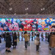 Huge placard showcasing manga heroes like Luffy featured in Weekly Jump magazine at the annual free event Jump Festa '23 in Makuhari Messe International Exhibition Hall.