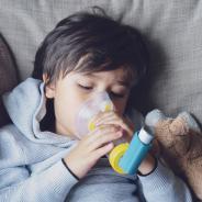 child using asthma inhaler