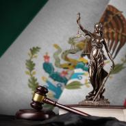 Mexico flag with statue of lady justice, constitution and judge hammer on black drapery. Concept of judgement.