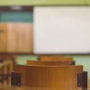 Lecture room or Examination room.School empty classroom with desks and chair.
