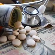 Pill bottle with pills and dollar bill rolls inside