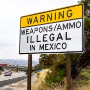 Road sign near U.S.-Mexico border that says "Warning: Weapons/ammo illegal in Mexico"