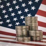 stacks of metal money are on the American flag. Financial system city concept. US coins and American flag 