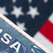 VISA to the USA and the flag of the United States of America. work and travel documents for visiting the USA. Visa for immigration.