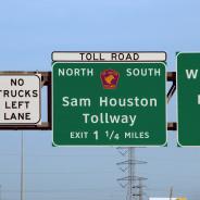 City traffic sign over the streets Sam Houston Tollway 