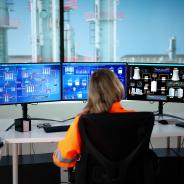 Woman watching oil and gas infrastructure monitors