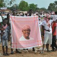 Supporters of President Umaro Sissoco Embalo show a red keffiyeh bearing his image during a political rally in Bissau
