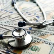Stethoscope on top of U.S. bills