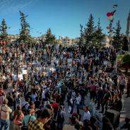 Unrecognizable crowd of ethnic protesters during rally on city street