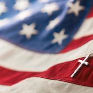 Christian cross necklace on American flag.