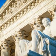  Equal Justice Under Law inscription in the neoclassical columned facade at the entrance to the US Supreme Court building in Washington DC 