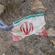 Iranian flag amidst debris
