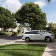 Luxury car parked on the driveway of a house in a Florida residential area reserved for mid aged people, USA 2017