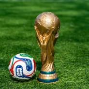  May 7, 2026, United States. The trophy of the 2026 FIFA World Cup and the official Adidas Trionda ball on the green lawn of the stadium. 