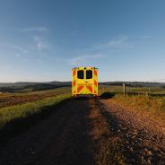 Yellow ambulance on a dirt road: medical transport in rural area