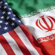 Close up view of the draped national flags representing the United States and Iran illustrating diplomatic relations issues.