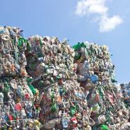 Stack of plastic bottles for recycling against blue sky