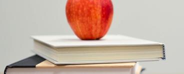Apple on top of stack of books