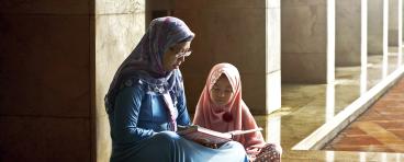 Mother and daughter reading book