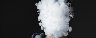Person blowing out vape smoke