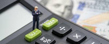 Calculator atop dollar bills