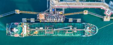 An oil tanker docks at a port.