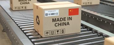 Boxes labeled "MADE IN CHINA" move along a production line.