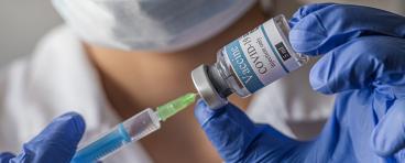A medical worker fills a syringe with the COVID-19 vaccine 