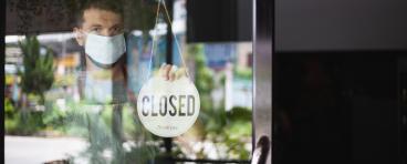 A man closes his business due to the COVID-19 pandemic.