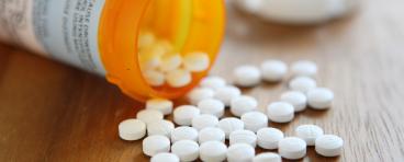 Prescription opioid medication pills spilled onto table