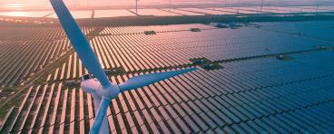 Wind turbine over solar farm