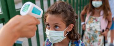 Student gets temperature checked at school