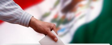 Ballot box in front of the Mexican flag