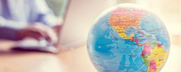 A globe sits on a desk.