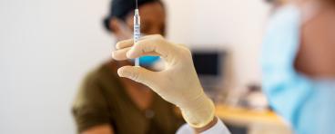 A nurse administers a COVID-19 vaccination.