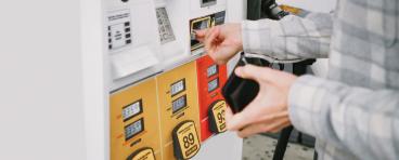 A person pays for gas at the pump.