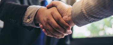 Two business partners shake hands.