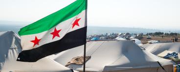 The Syrian revolution flag waves over refugee camps.
