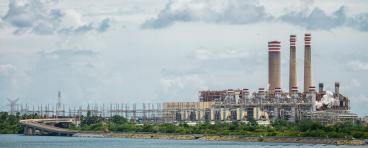 A Pemex refinery in Mexico, viewed from across a body of water.
