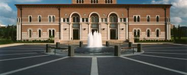 The front of Baker Hall, from across the plaza, with fountain in foreground
