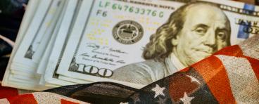 American flag envelopes stack of $100 bills