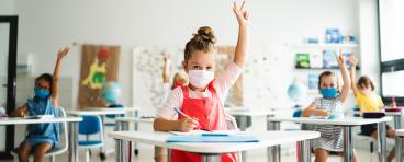 Young students wear COVID masks in the classroom