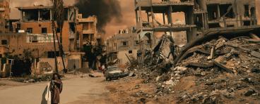Walking in destroyed city, a little girl seeks shelter
