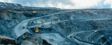 Trucks and the excavator in an open pit 