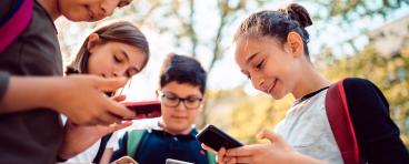  Kids playing video games on smart phone after school