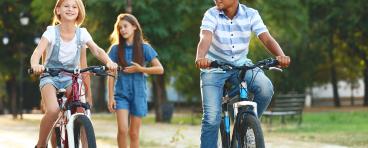  Friends riding bicycles and walking in the park