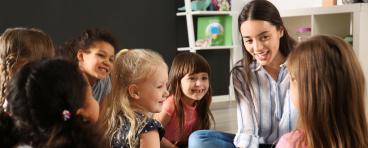 Children with nursery teacher in kindergarten