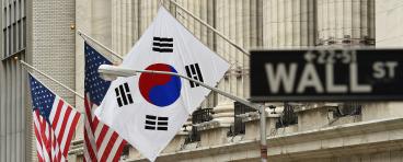 The South Korean flag (R) flies with US flags outside the New York Stock Exchange before South Korea's Ambassador to the US, Ahn Ho-Young rang the opening bell at the NYSE May 13, 2014 in New York.