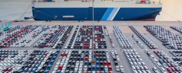 Aerial view vehicle carrier vessel loading car for shipping to worldwide, Large RoRo (Roll on/off) vehicle car carrier, New car lined up in the port for import export around the world.