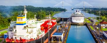 Two cargo ships transiting the Panama Canal.